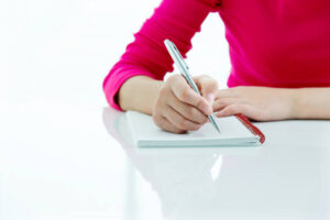Woman writing on a note pad