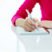 Woman writing on a note pad